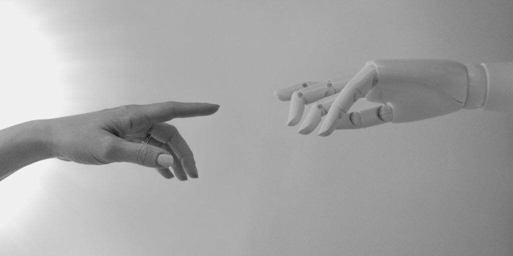 future trends, Black and White Photo of Human Hand and Robot Hand