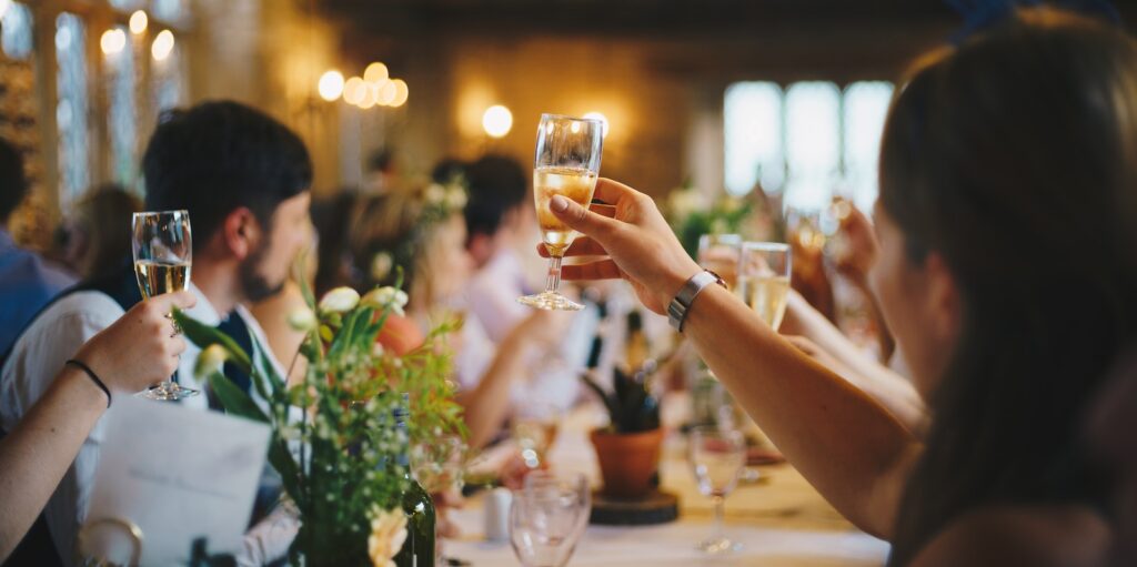 celebration, people raising wine glass in selective focus photography