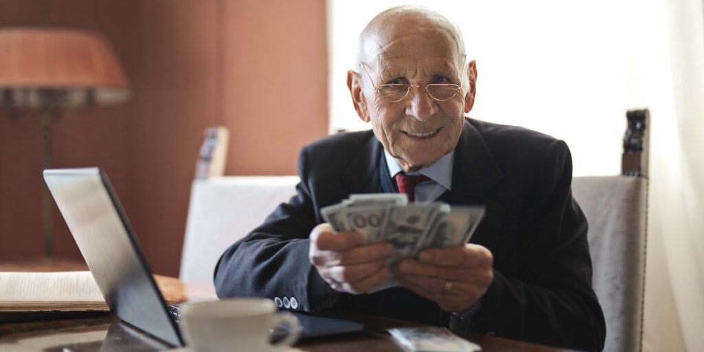 senior businessman holding money, retirement