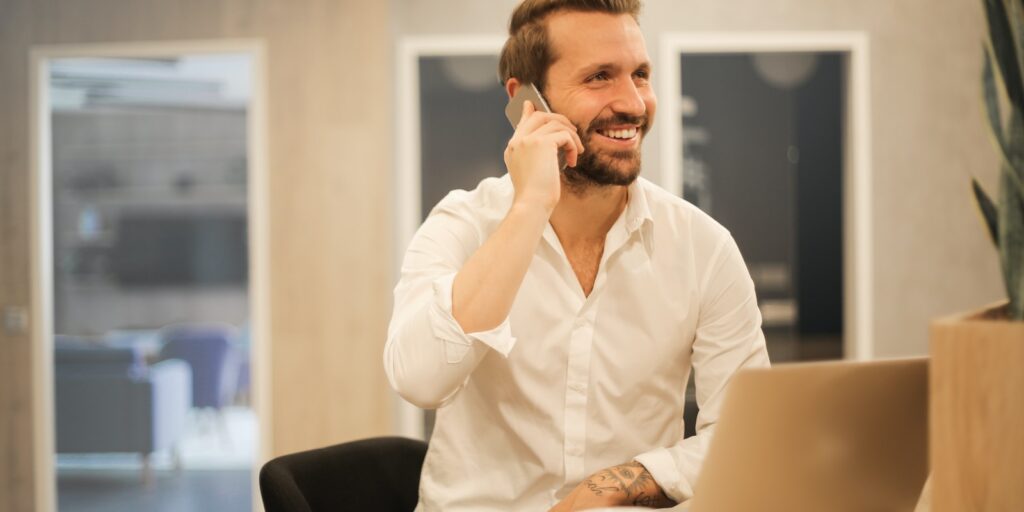 Corporate Rental Apartment, man using smartphone on chair