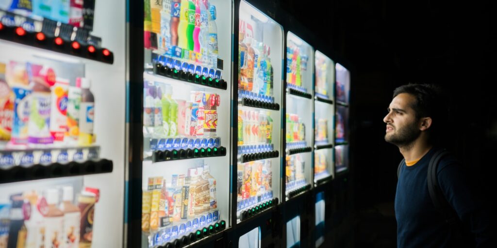 options, man on front of vending machines at nighttime