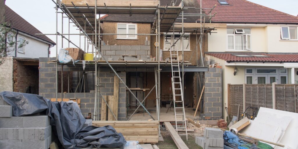 spec house, brown wooden ladder beside brown wooden wall